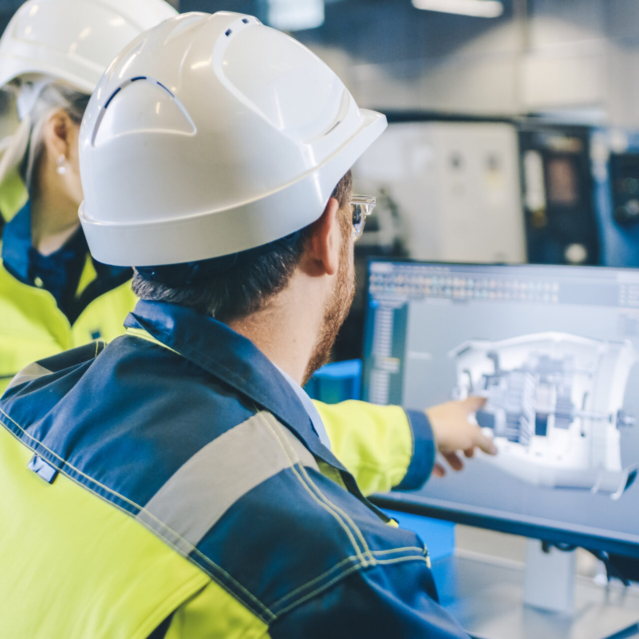 At the Factory: Male Mechanical Engineer and Female Chief Engineer Work Together on the Personal Computer, They Discuss Details of the 3D Engine Model Design.